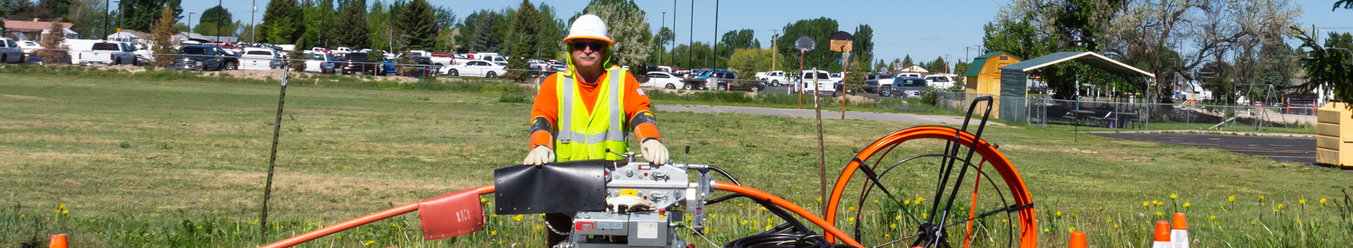 Photo of a worker in front of fiber tubing